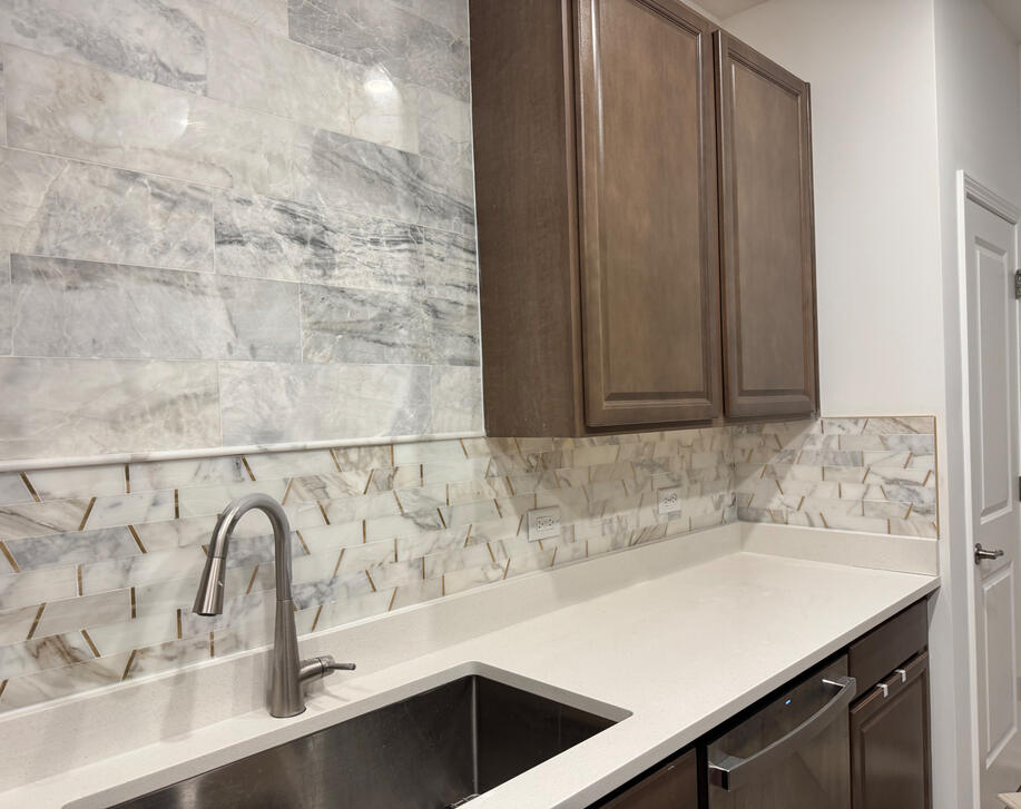Kitchen backsplash with marble-look tile and mosaic detail Kitchen backsplash with marble-look tile and mosaic detail