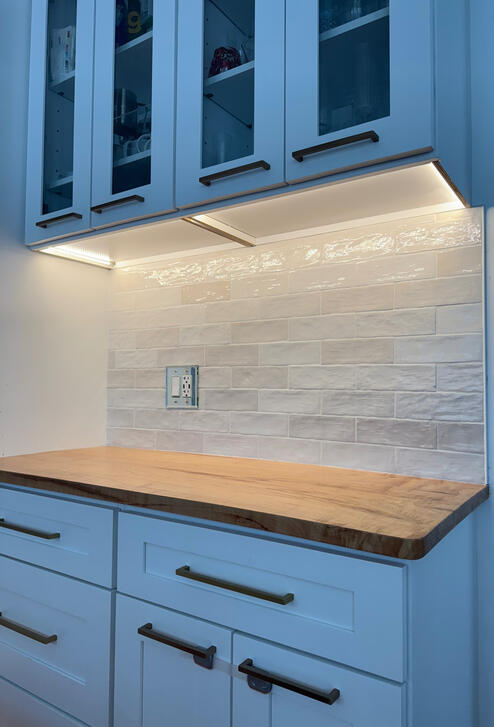 White textured tile backsplash above wood countertop White textured tile backsplash above wood countertop